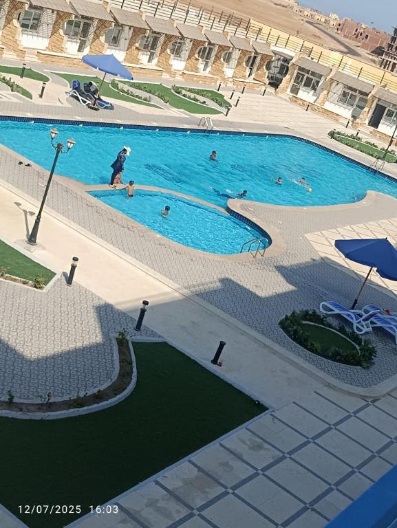 a large swimming pool with people swimming in it at isis MARINA in Hurghada