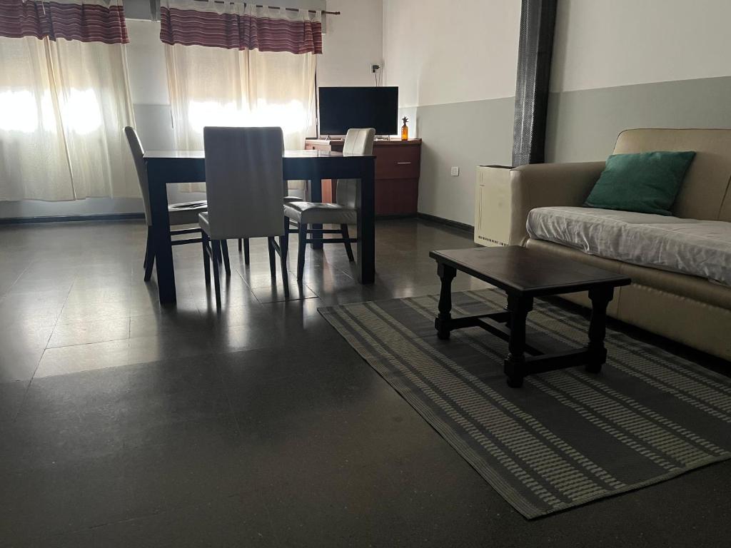 a living room with a table and chairs and a couch at Complejo Semaso in Santa Rosa