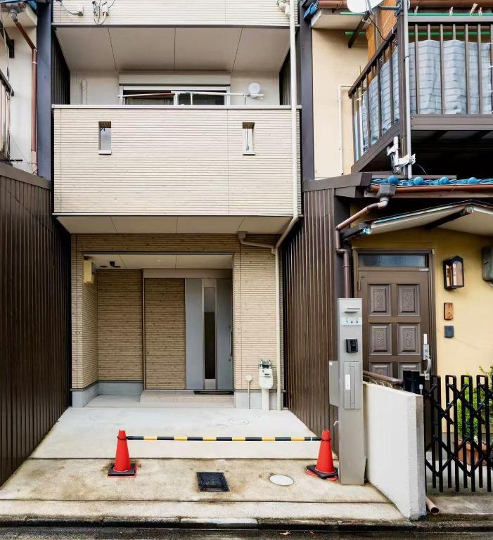 a building with two orange cones in front of it at 夏様二条南 6 min walk Nijo St, Entire private house, 3 bedrooms, Up to 6 guests, 2 toilets in Kyoto