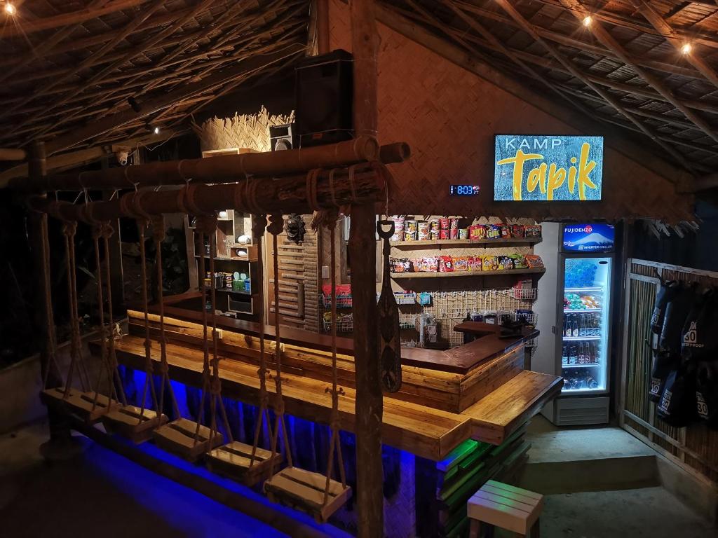 a bar in a restaurant with aperature at Kamp Tapik - Sibaltan in El Nido