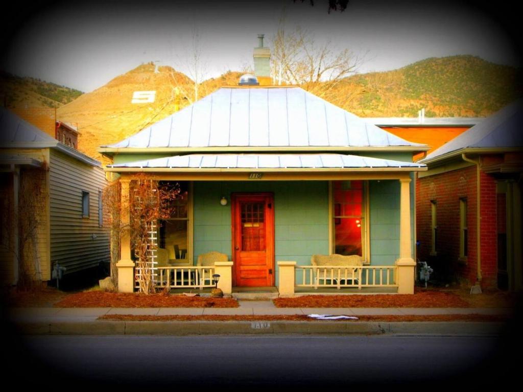 a green house with a red door on a street at Quaint Home On Alpine Park, Downtn Salida Str461 in Salida