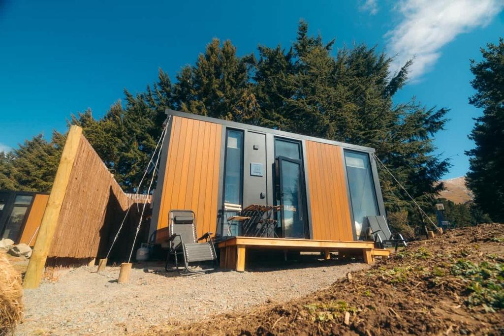 a tiny house sitting on top of a hill at Avalanche Creek Cabin in Burkes Pass