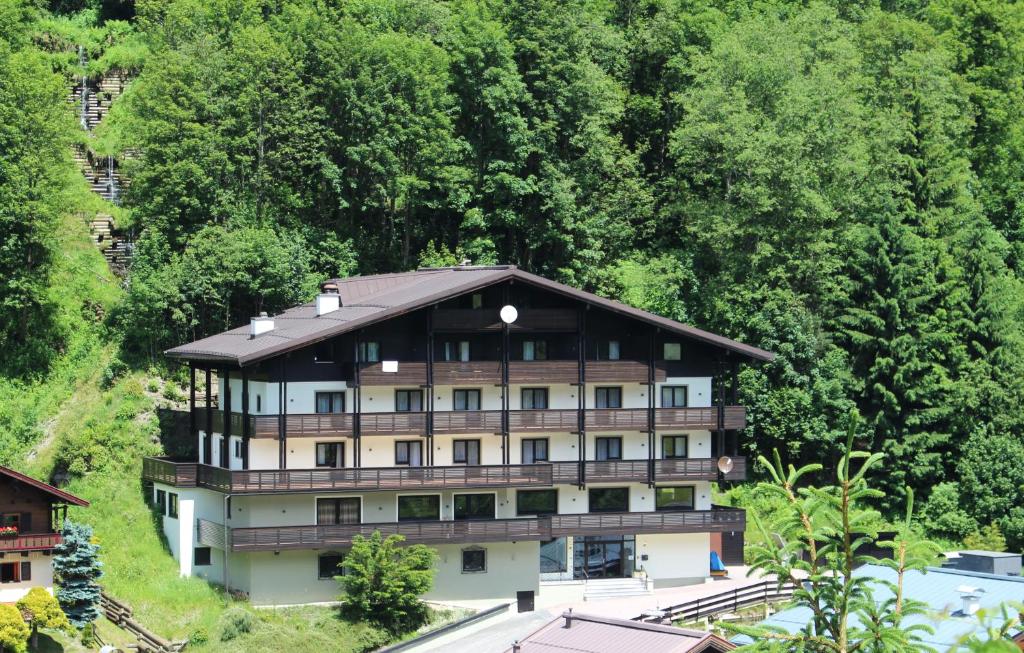 a large building with a view of a river at Panorama Landhaus in Saalbach-Hinterglemm