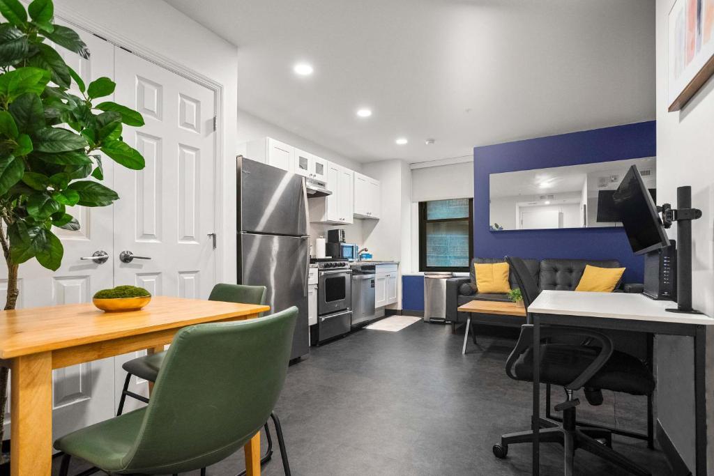 a kitchen with a table and a desk with chairs at CozySuites Stunning 1BR in Downtown Pitts #1 in Pittsburgh