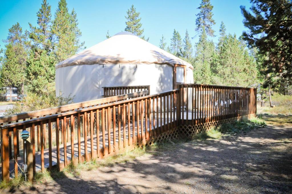 a yurt with a wooden fence next to it at Bend-Sunriver Camping Resort Wheelchair Accessible Yurt 13 in Sunriver