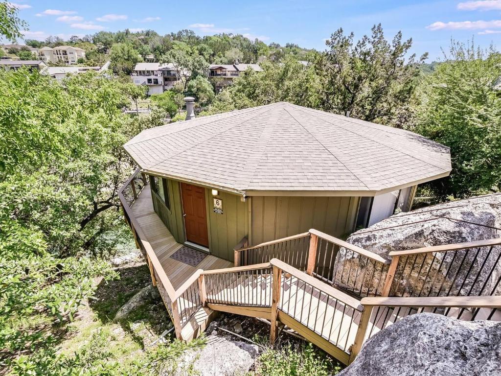 a house with a deck with a roof at Lakefront Bungalow - Community Poolhot Tub #6 in Lakeway