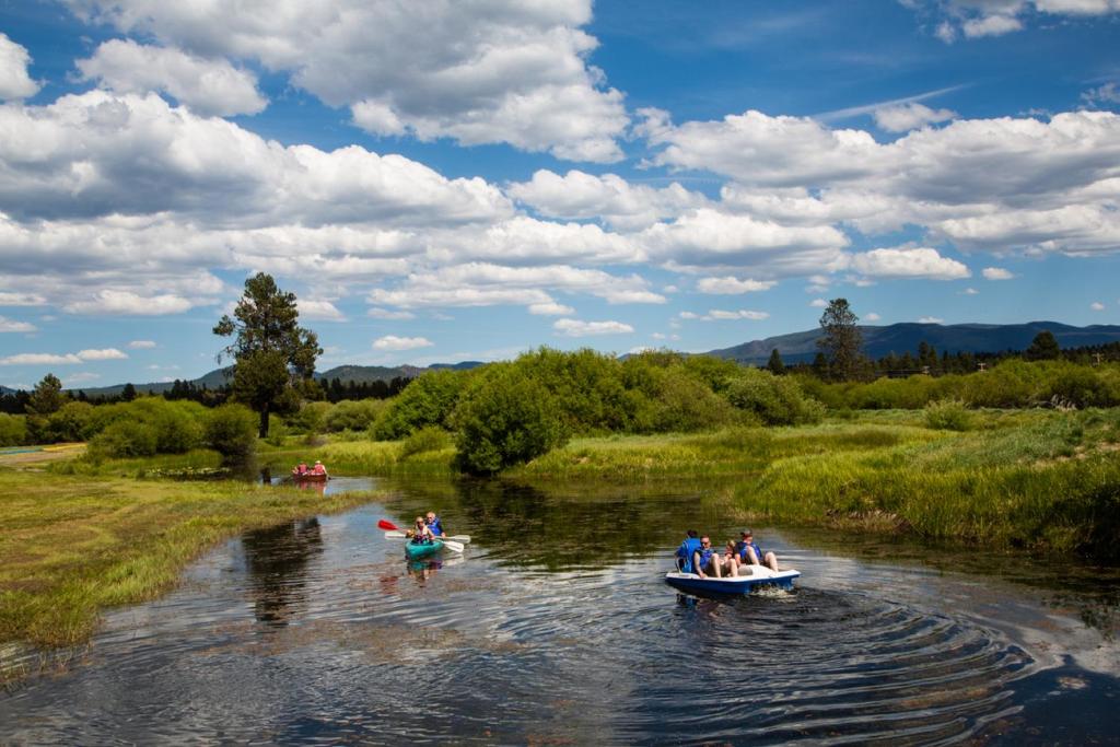 a group of people in boats on a river at Bend-Sunriver Camping Resort Two-Bedroom Cabin 5 in Sunriver