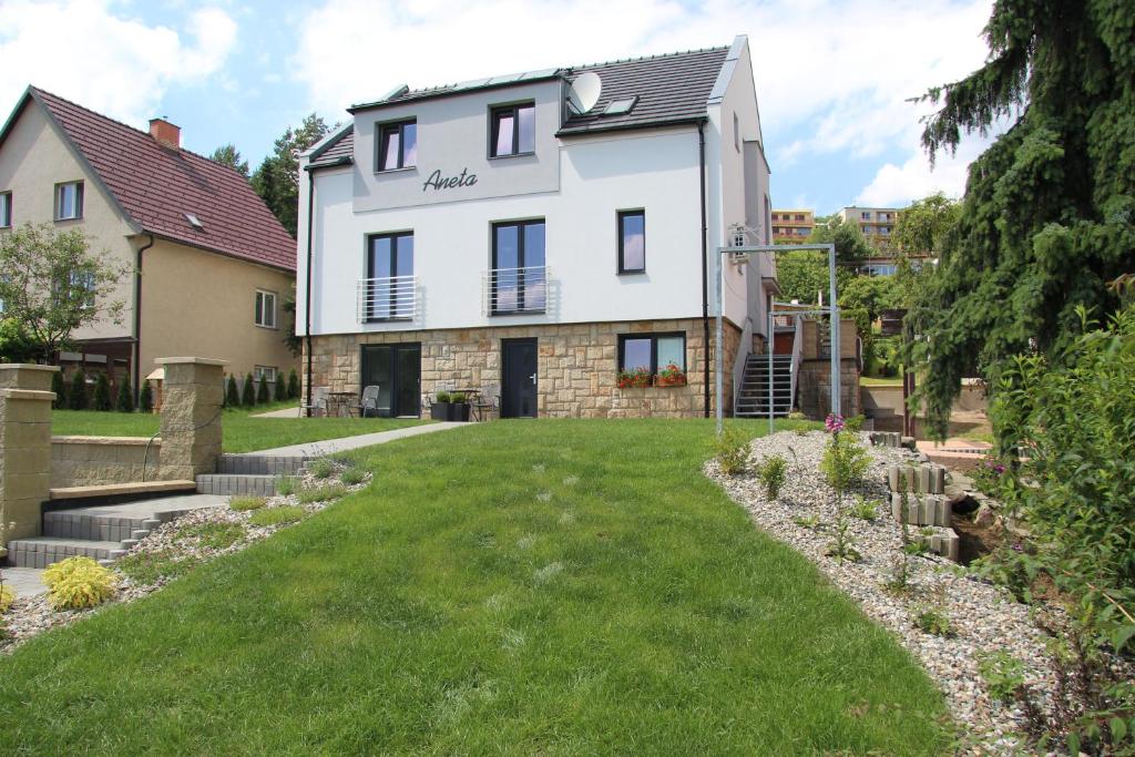 a house with a lawn in front of it at Vila Aneta in Luhačovice