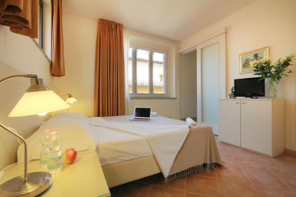a bedroom with a bed with a laptop on it at Relais Panoramic Cathedral Florence in Florence