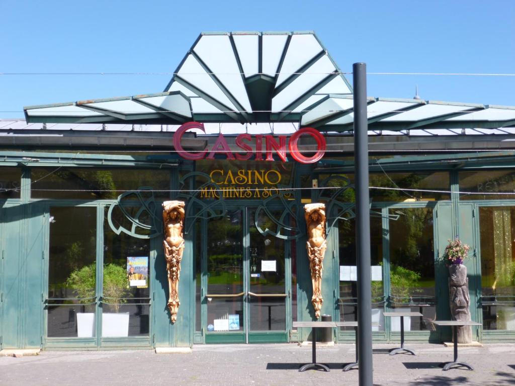 a building with a sign for a casino at La Gentiane in Le Mont-Dore