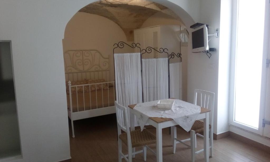 a dining room with a white table and chairs at House Rental for Tourists in Monopoli