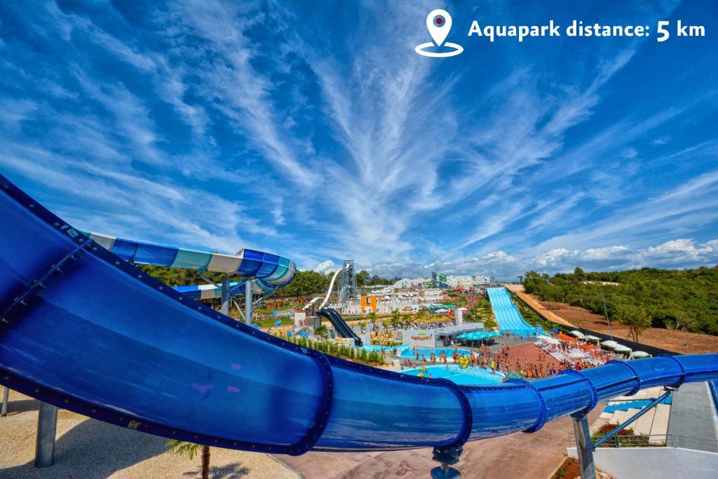 an amusement park with a slide at an amusement park at Aminess Vival Maestral Hotel in Novigrad Istria