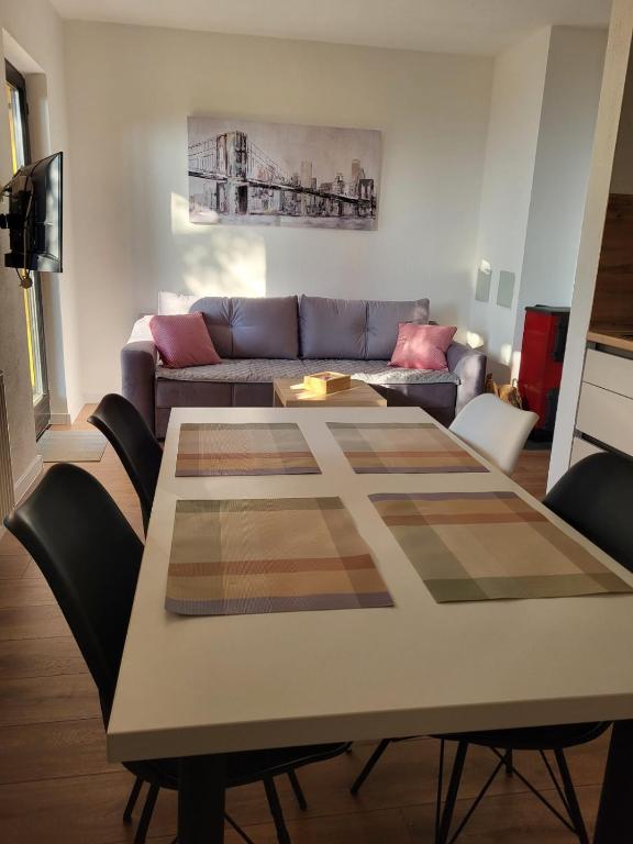 a living room with a table and a couch at Friends 2 Vlašić in Vlasic