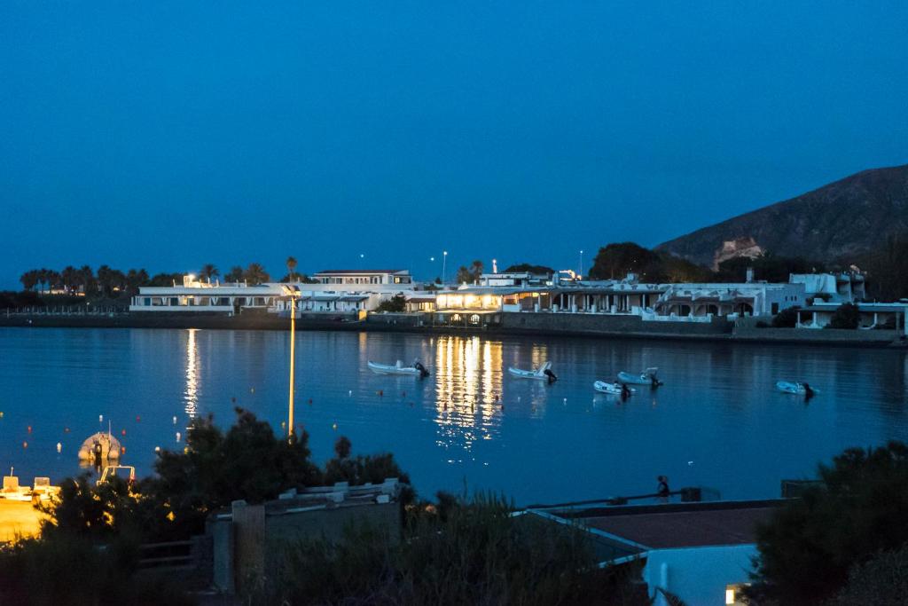 a view of a harbor at night with boats in the water at Mari del Sud Resort in Vulcano