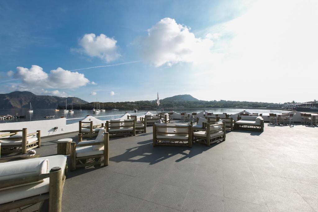 a group of chairs sitting on a dock near the water at Mari del Sud Resort in Vulcano