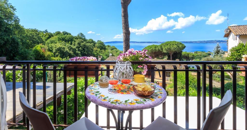 a table on a balcony with drinks on it at La perla di Trevignano in Trevignano Romano