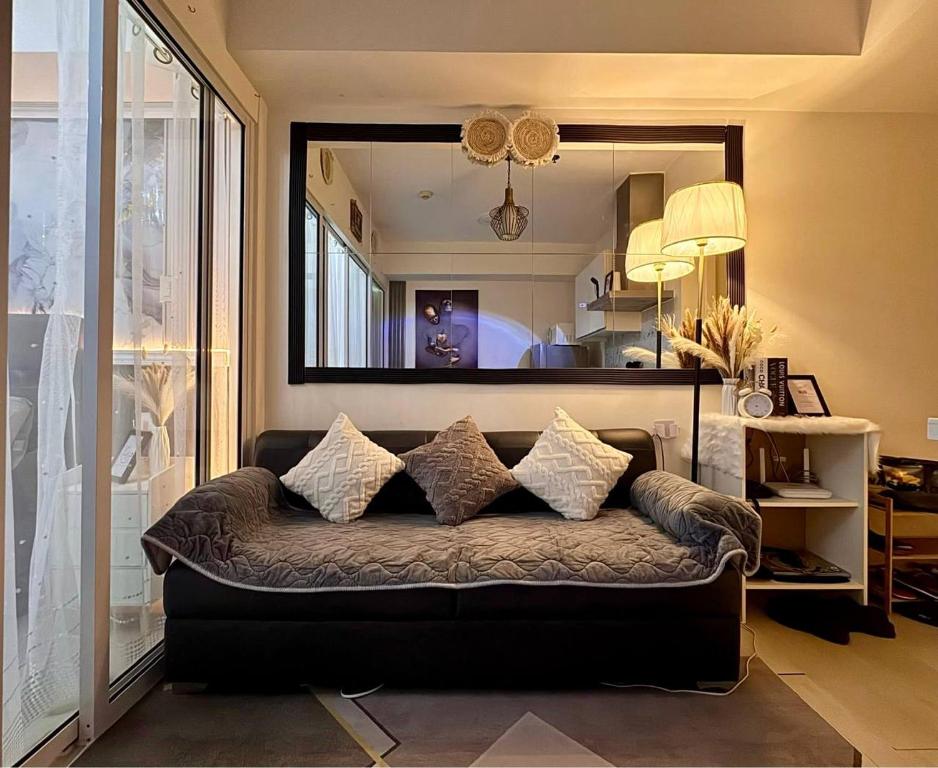a couch in a living room with a mirror at Dream Escapade in Manila