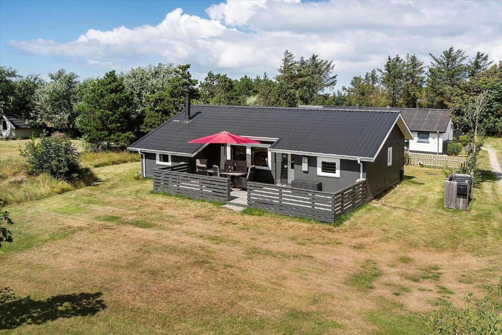 a house with a red roof in a yard at 1353-Snedsted-Ebenezervej-24 in Snedsted