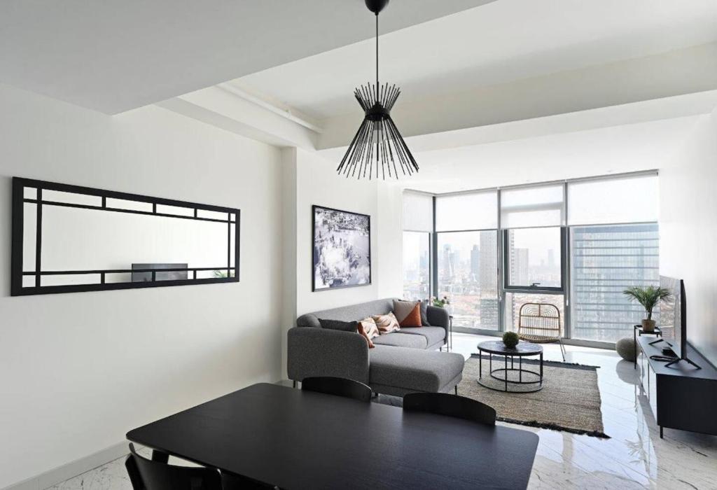 a living room with a couch and a table at Beautiful Modern 1bd Condo Views W Poolgym! #223 in Istanbul
