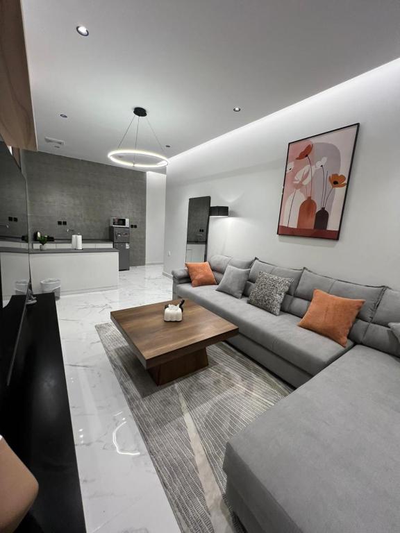 a living room with a couch and a table at Luxury 2BR Apartment -Prime Area in Jeddah