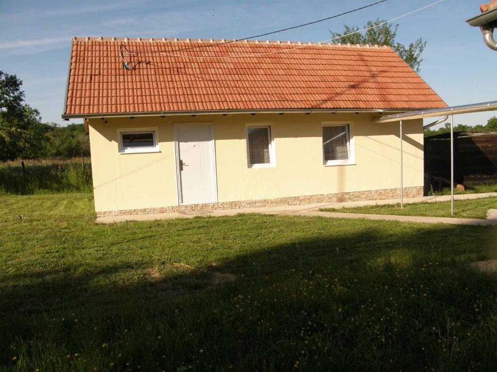 a small yellow house with an orange roof at Country cottage 