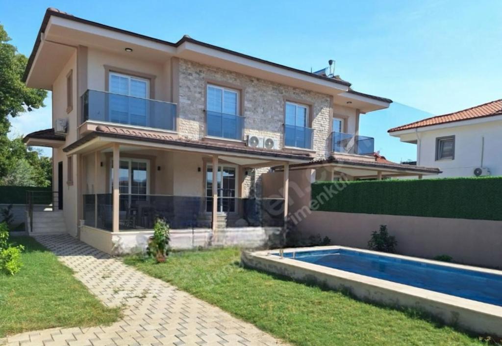 een villa met zwembad en huis bij Likya Karya Villaları in Koycegiz