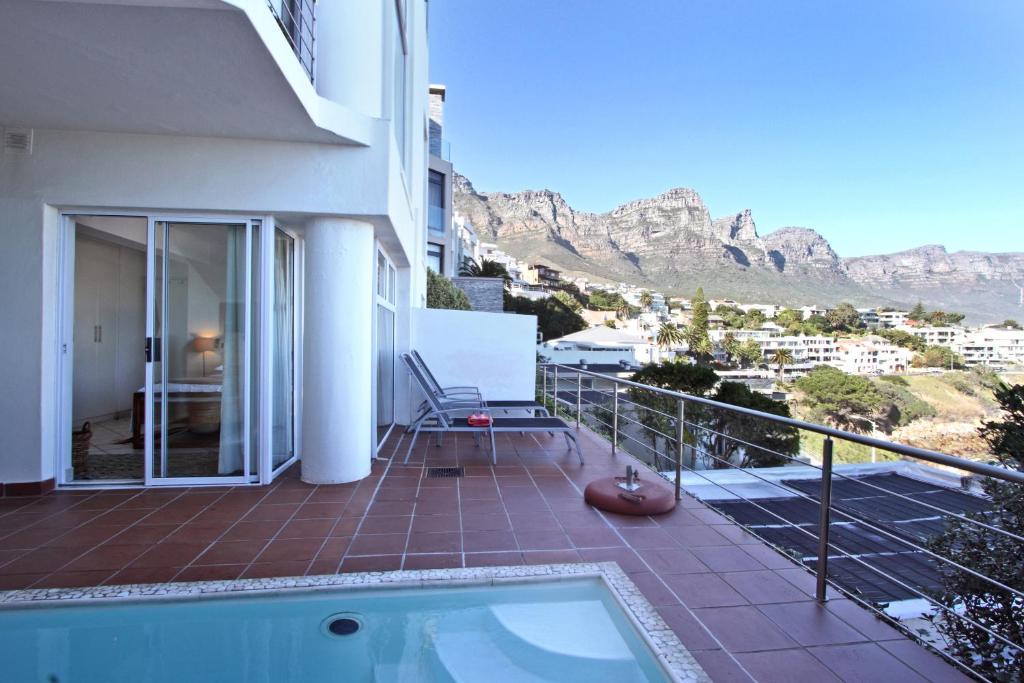 a balcony of a house with a view of the mountains at Camps Bay Terrace Suite in Cape Town