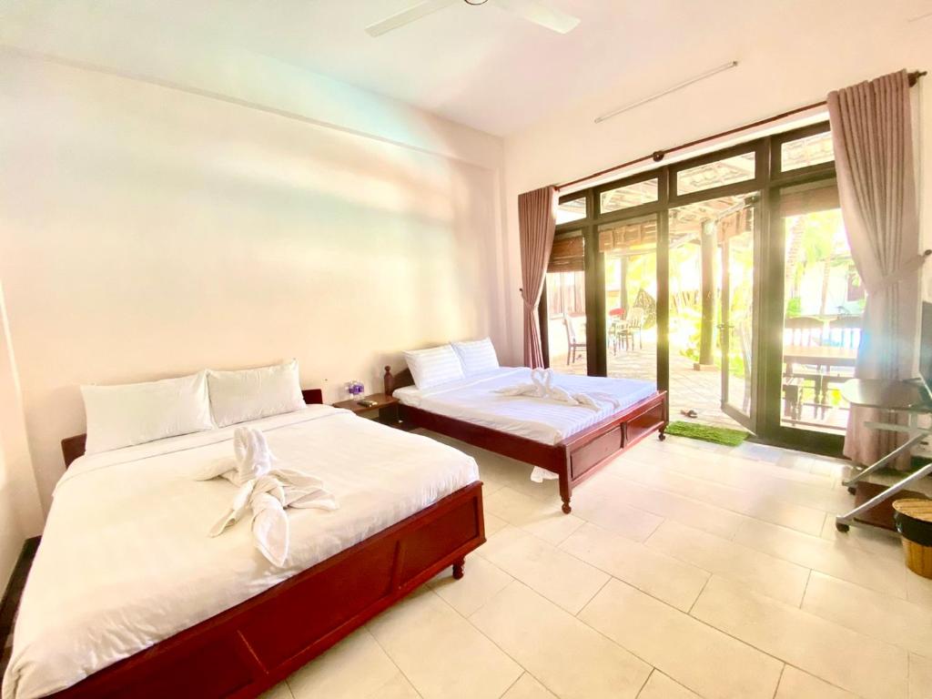 Giường trong phòng chung tại JAGUAR HOUSE RESORT Muine
