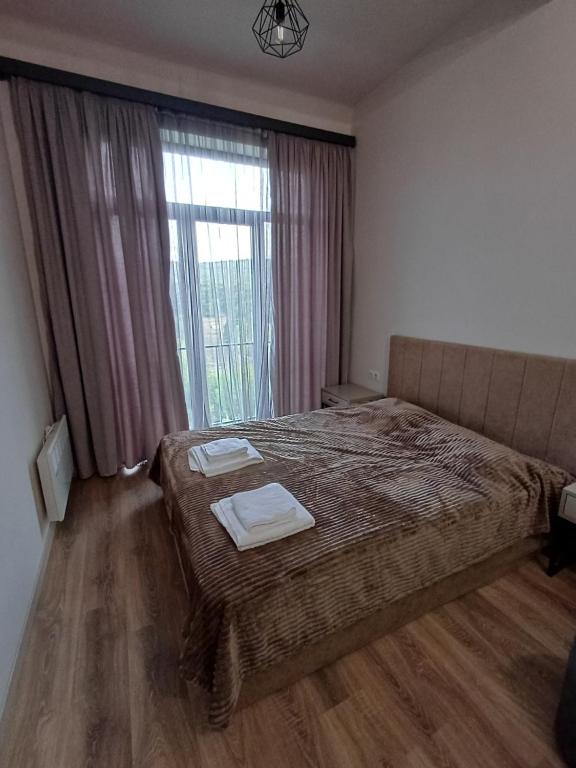 Ένα ή περισσότερα κρεβάτια σε δωμάτιο στο Kechi View Apartment