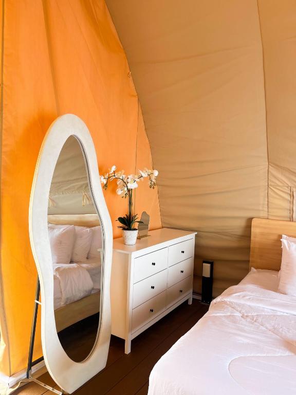 a bedroom with a mirror and a bed at Reef Resort - Samal Island View Unit B9 in Kaputian