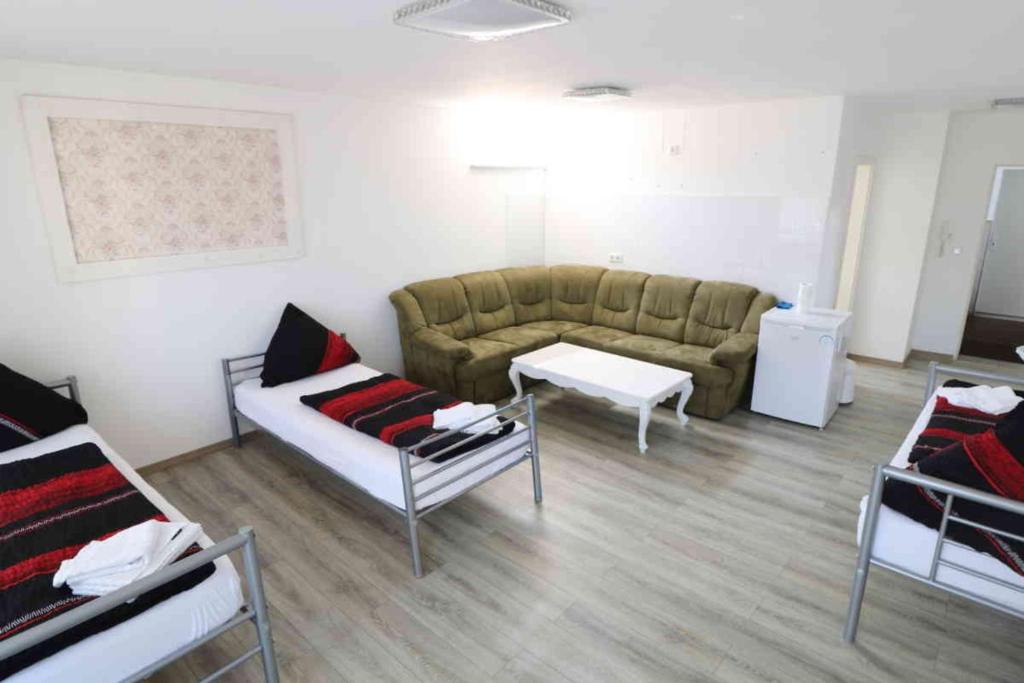 a living room with a couch and a table at Aparthotel Kompass A 201 in Essen