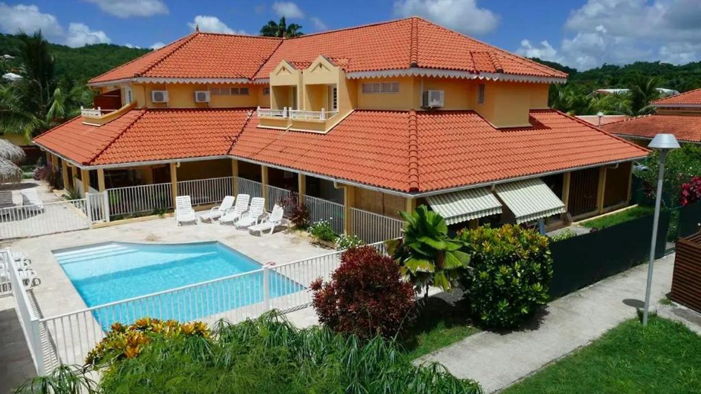 an aerial view of a house with a swimming pool at Maison en résidence privée avec piscine accès plage in Les Trois-Îlets