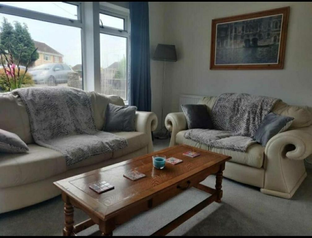 a living room with two couches and a coffee table at 4-Bedrooms - Perfect for those working in Bridgend in Bridgend