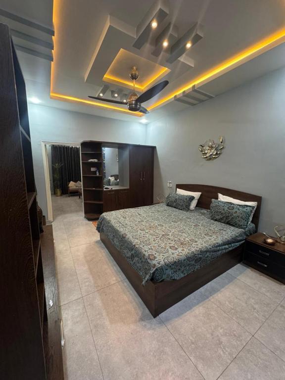 a bedroom with a large bed in a room at 1 Bed Room Apartment near Tariq road in Karachi