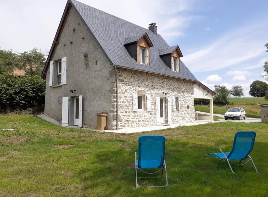 two blue chairs in front of a house at Chez le Bessou 