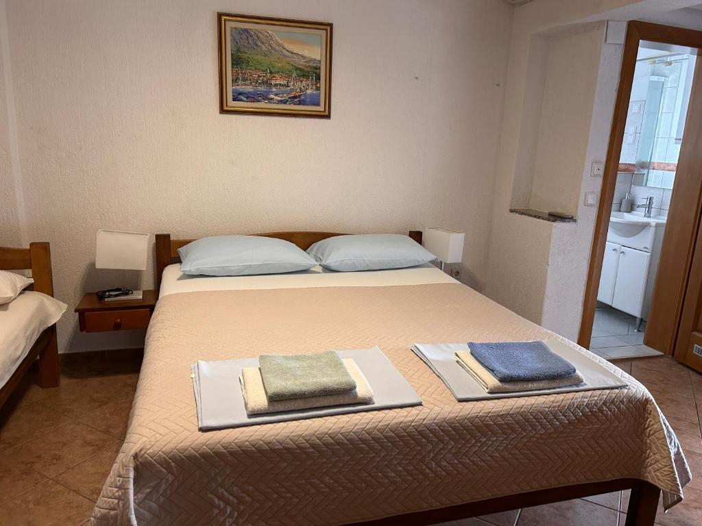 a bedroom with a bed with two towels on it at Vila Tesmija in Baška
