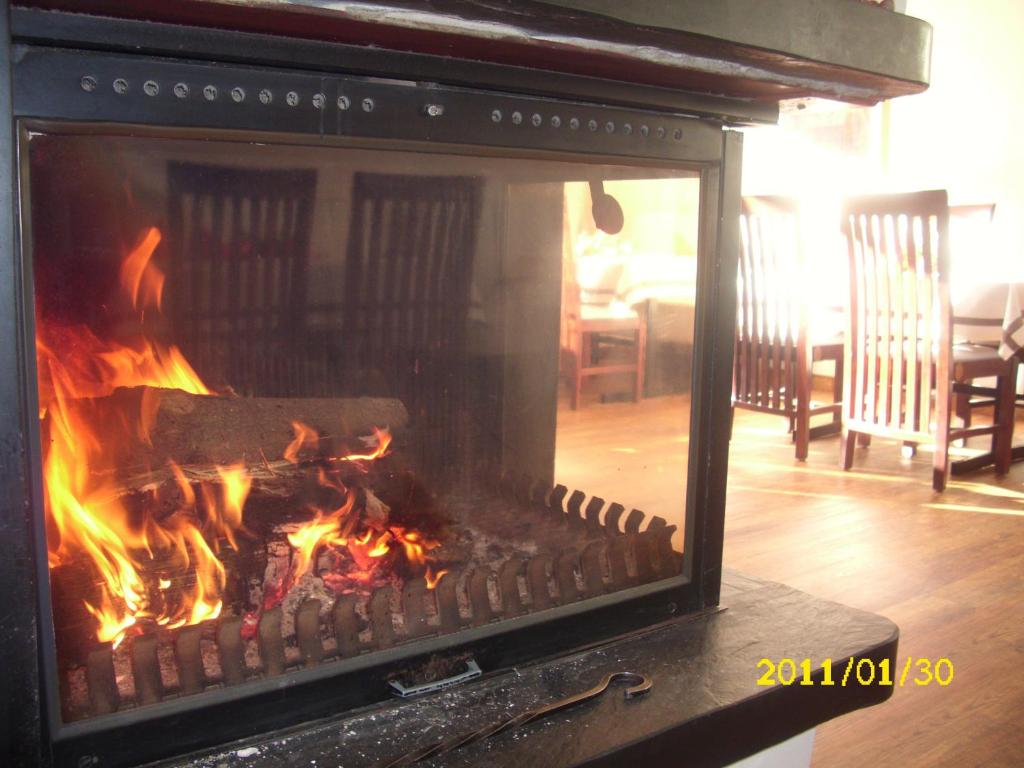 a fire in a fireplace in a living room at Landhotel Pingel in Sundern