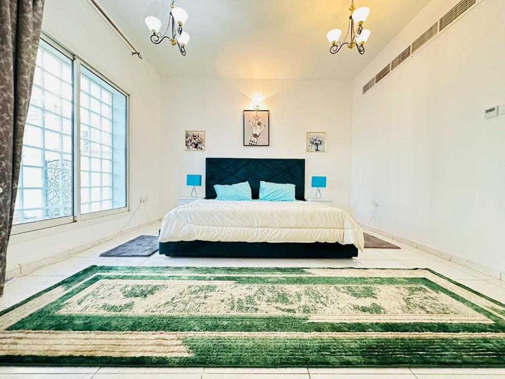 - une chambre avec un lit et un grand tapis dans l'établissement Albarsha Villa Fully Furnished Luxury Private Master Room Ensuite Huge Space Deluxe, à Sabkhah