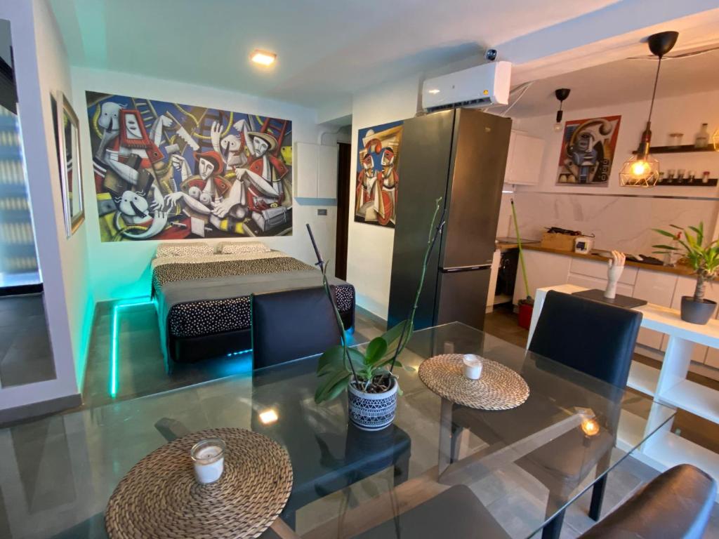a living room with two tables and a refrigerator at Magnifique appartement près du centre in Barcelona