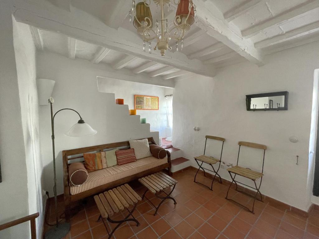 a living room with a couch and a staircase at ESGLESIA 4 by SOM Menorca in Fornells