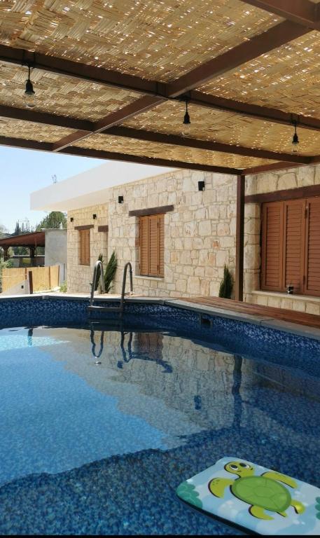 a swimming pool in front of a house at Daglas suit in Kannaviou
