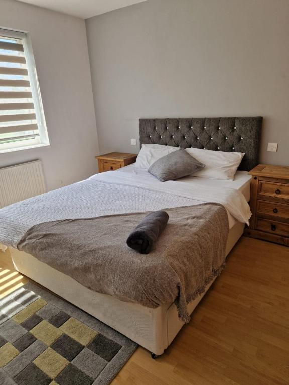 a bedroom with a large bed with a pillow on it at Spacious Luxurious Serviced Accomodation in Doncaster
