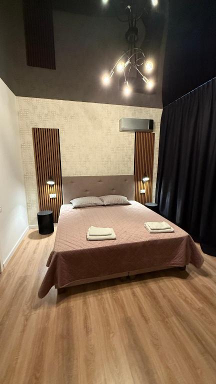 a bedroom with a bed with two towels on it at Cozy Studios Barlad in Bîrlad