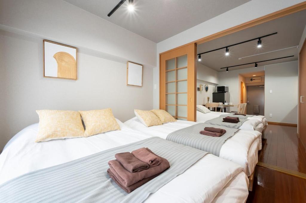 a group of four beds in a room at Near Shibuya Station 4Beds 5Max A175 in Tokyo