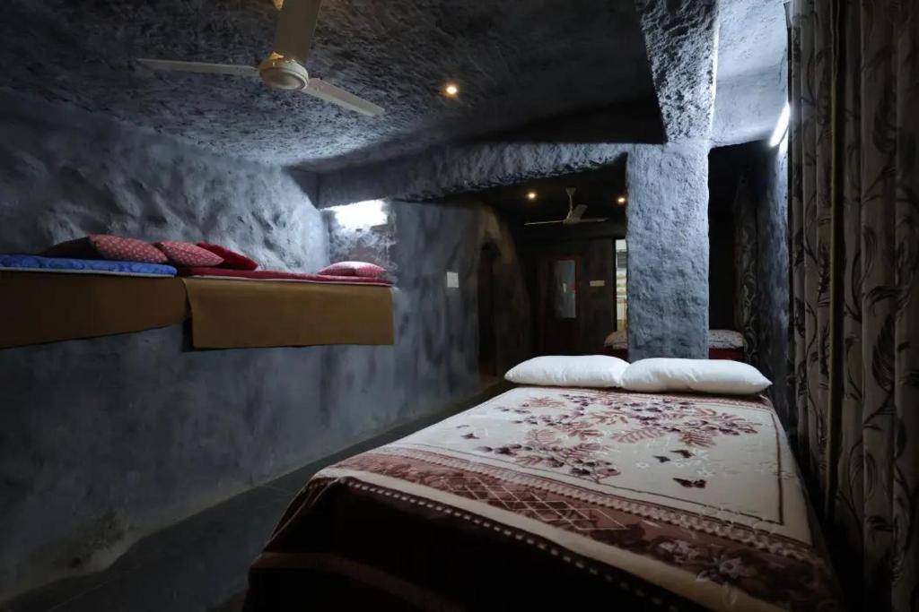 a bed in a room with two beds in it at The Royal Summit, Panchalimedu in Suryanelli