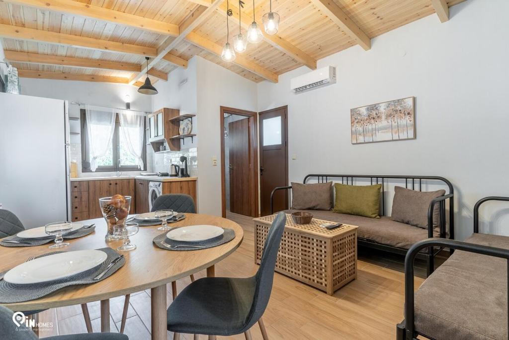 a living room with a table and a couch at Myrtali's - Tzoumerka Mountain View Retreat 