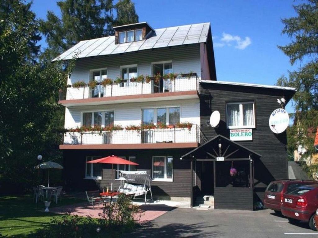 a large house with a balcony and a patio at Gościniec Bolero in Szklarska Poręba