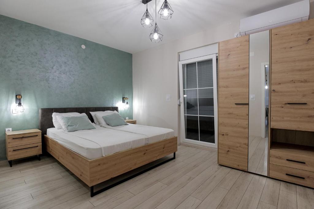 a bedroom with a large bed and a large closet at 4-teen in Jagodina