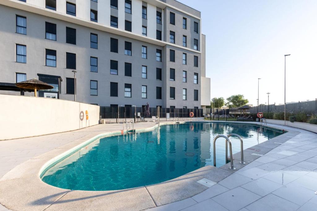a large swimming pool in front of a building at Be Casa - Rivas in Rivas-Vaciamadrid