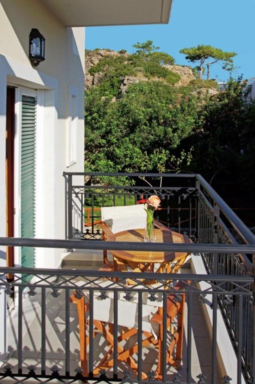 a balcony with a table and a chair at Aretousa in Sougia